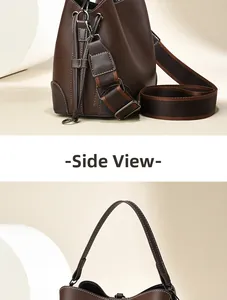 Detail view of coffee leather bucket bag with white stitching and wide fabric strap