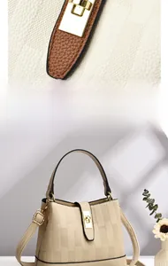 Detail of golden metal lock and lychee leather check pattern on the beige bucket bag