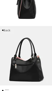 Detail view of the black textured leather tote bag back pocket and reinforced base