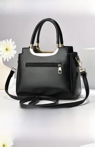 Detail view of the black lychee pattern leather handbag featuring back zipper pocket
