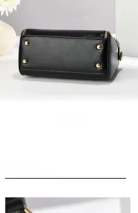 Detail view of the black leather bucket bag bottom with four golden protective metal feet