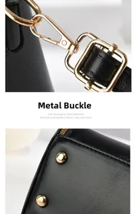 Detail of the golden swivel hook and protective bottom rivets on black leather handbag