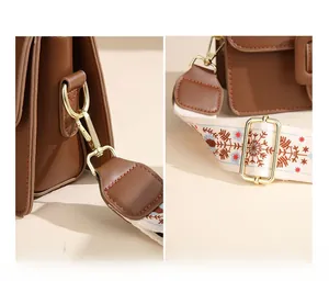 Dettaglio degli accessori in metallo dorato e della tracolla a fiori vintage sulla borsa