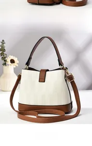 Detail view of the elegant two-tone bucket bag with side and back texture display