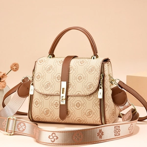 Beige and brown monogram crossbody bag with gold hardware and wide jacquard strap