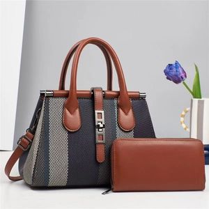 Two-piece set with blue grey woven handbag and brown leather wallet set on grey background