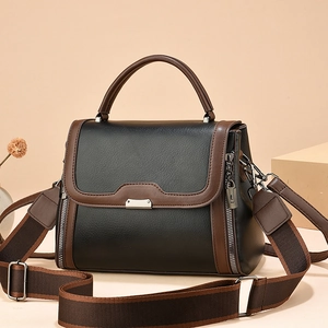 Chic two-tone black and brown leather crossbody handbag with wide adjustable shoulder strap