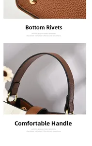 Detail of brown lychee grain bag with gold bottom studs and comfortable handle