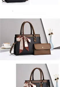 Close-up of black lychee grain tote bag with silk scarf and matching brown wallet pouch