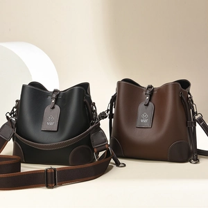 Vintage bucket bags in black and brown leather with wide straps and MMF tag