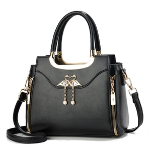 Classic black PU leather handbag with golden swan buckle and pearl charm detail