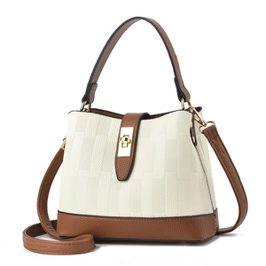 Minimalist white and brown bucket bag with lychee texture and gold rotating lock