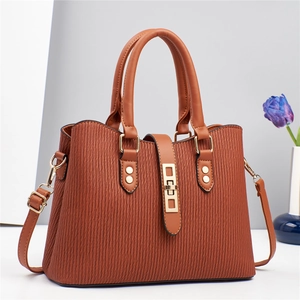 Elegant brown macaron handbag with vertical ribbed texture and gold lock on white background