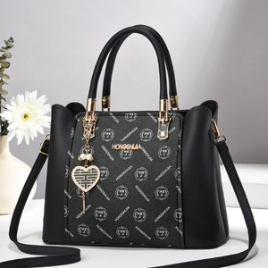 Sac à main élégant en cuir noir avec motif monogramme et pendentif cœur pour femme