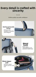 Close-up of reinforced handles and gold-tone hardware on navy blue leather tote bag