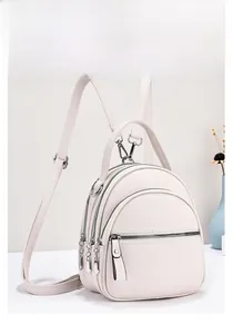 Detail view of cream mini backpack with lychee texture and multi-layer zippers