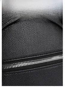 Close-up of black PU leather backpack with crocodile texture and silver metal zipper detail