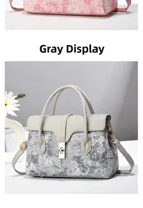 Close-up of vintage floral jacquard bucket bag with grey leather strap and gold hardware
