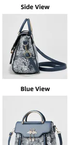 Detail of blue jacquard handbag with swan metal clasp and pearl accents