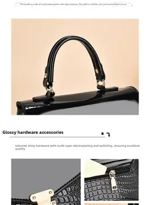 Detail of crocodile embossed leather handle with durable polished gold hardware