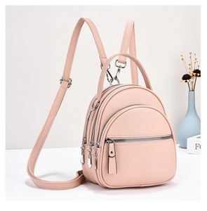 Detail view of pink lychee pattern PU leather mini backpack with three zipper layers