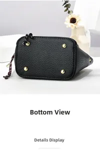 Vue détaillée du fond du sac en cuir grainé noir avec quatre clous de protection dorés