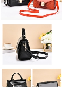 Close-up of crocodile textured glossy leather bag with elegant golden twist lock detail