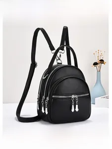 Detail of black lychee grain PU leather mini backpack with silver water drop zippers
