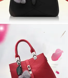 Detail of red and black lychee leather handbags with metal twist locks and leaf charms