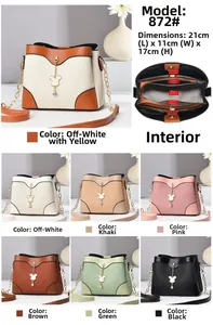 Detail of multi-compartment structure and gold chain on cream wavy textured crossbody bag