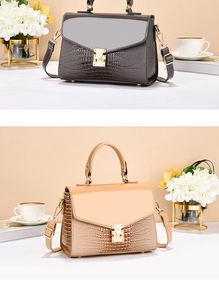 Detail of luxury crocodile pattern faux leather shoulder bags with gold metal square buckles