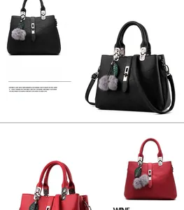 Detail of pebbled leather texture with V-shaped stitching and metallic lock on black tote bag