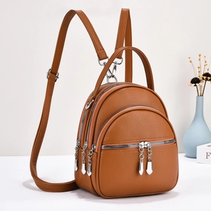 Caramel brown pebbled leather multi-pocket backpack for women with silver zippers
