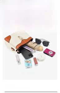 Detail of spacious interior compartments in a beige crossbody bag showing organized storage
