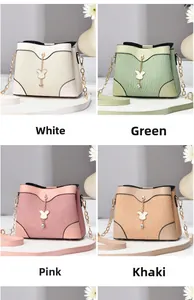 Detail showing cross-pattern textured handbags in white, green, pink, and khaki colors