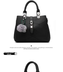 Detail of black pebbled leather tote showing side view with silver padlock and plush charm