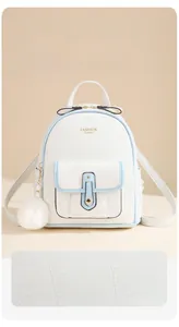 Detail of white PU leather backpack with water-resistant texture and plush ball charm