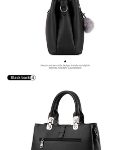 Macro view of black pebbled leather handbag featuring silver zippers and pompom detail