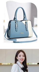 Detail of color-block tote bag featuring golden metal logo and adjustable shoulder strap