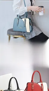 Detail view of premium cowhide leather handbag with color-block design and metal hardware