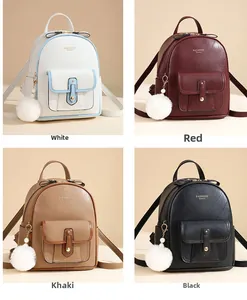 Detailed view of mini textured leather backpacks in white, red, khaki, and black colors