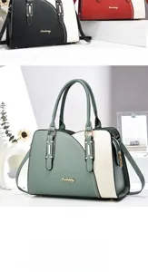 Close-up of color-block tote handbags with top handles and golden metallic logo details
