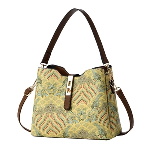 Elegant bucket bag with Chinese landscape patterns and brown leather handles in yellow
