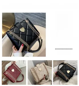 Detail of quilted PU leather tote bags with gold heart buckle and chain straps in three colors