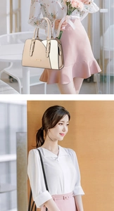 Close-up of elegant cream color-block handbag showing texture and stylish dual handles