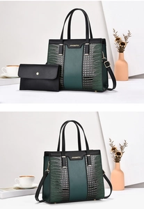 Detail of dark green contrast tote bag with crocodile pattern and golden hardware set