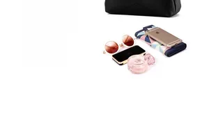 Close-up of spacious black pebble leather bag showing storage for phone and accessories