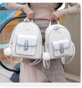 Detail of white cross-grain leather backpacks with fashion queen logo and pearl pompom