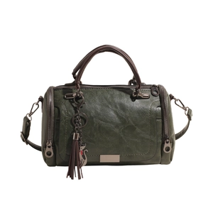Vintage dark green Boston pillow bag with soft leather texture and cat tassel charm