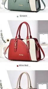 Detail of elegant crossbody handbags in green and wine red with gold metal hardware